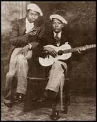 Nighthawk-on-guitar-with-brother-Percy-on-harmonica-circa-1930